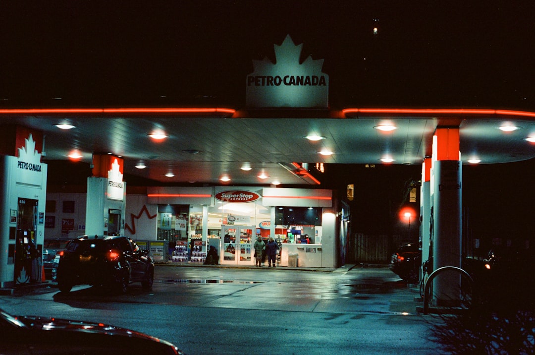 Petro-canada gas station at night with neon lights.