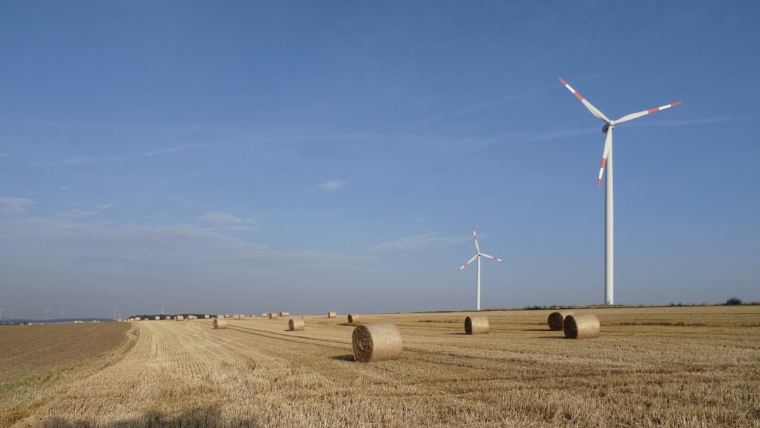 Wind turbines in a field with hay bales
